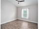 Bedroom with an airy feel, featuring a large window and light-colored walls at 12164 Se 85Th Ct, Belleview, FL 34420