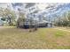 Wide shot of backyard featuring large screened patio extending from house at 12330 Sw 43 St Rd, Ocala, FL 34481