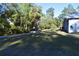 Exterior view of the house with large backyard surrounded by lush landscaping at 12330 Sw 43 St Rd, Ocala, FL 34481