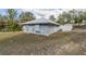 The exterior of this one-story home features a modern metal roof and stucco facade at 12330 Sw 43 St Rd, Ocala, FL 34481