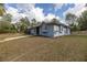 A single story home features a metal roof, stucco exterior and a screened in enclosure at 12330 Sw 43 St Rd, Ocala, FL 34481