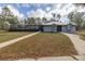 A one story home with a metal roof, covered porch and long driveway at 12330 Sw 43 St Rd, Ocala, FL 34481