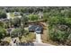 Aerial view of home, showcasing the driveway, landscaping, and surrounding trees at 14 Water Track Ct, Ocala, FL 34472