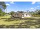 Expansive backyard with lush lawn and partial fencing, offering privacy at 14 Water Track Ct, Ocala, FL 34472