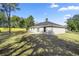 A spacious backyard with newly installed sod, a yellow fence, and a concrete patio at 14 Water Track Ct, Ocala, FL 34472