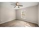 Bright bedroom with wood-look floors and a ceiling fan, with plenty of natural light from the window at 14 Water Track Ct, Ocala, FL 34472