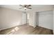 Bedroom with wood-look flooring, ceiling fan, and closet featuring ample storage space at 14 Water Track Ct, Ocala, FL 34472