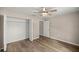 Bedroom with wood-look flooring, a ceiling fan, and a closet with ample storage space at 14 Water Track Ct, Ocala, FL 34472