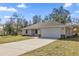 Charming single-story home featuring a well-manicured lawn and an attached two-car garage at 14 Water Track Ct, Ocala, FL 34472