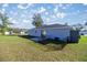 Backyard showcasing a fenced-in patio and spacious lawn, with the rear exterior of the home at 14560 Sw 25Th Ter, Ocala, FL 34473