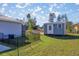 View of a backyard with a storage shed, black metal fence, and partial view of home's exterior at 14560 Sw 25Th Ter, Ocala, FL 34473