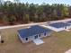 Aerial view of the home's exterior showing the backyard, patio, and nearby trees at 15850 Sw 33Rd Avenue Rd, Ocala, FL 34473