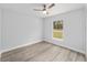 This bedroom has gray walls and light vinyl flooring, plus a double hung window at 15850 Sw 33Rd Avenue Rd, Ocala, FL 34473