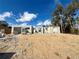 Under-construction block home reveals the initial framing amidst a sandy landscape and blue skies at 15864 Se 98Th Ter, Summerfield, FL 34491