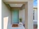 Inviting entryway with a vibrant blue door, decorative welcome mat, and potted plant at 17094 Sw 39Th Cir, Ocala, FL 34473