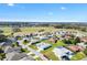 An aerial view of the home in a vibrant community with manicured lawns and a golf course at 17755 Se 117Th Cir, Summerfield, FL 34491