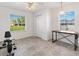 Bright room featuring neutral tile, two windows with shades, ceiling fan and light, and a closet at 17755 Se 117Th Cir, Summerfield, FL 34491