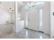 Bright foyer with decorative transom window, tile flooring, and a view of the living room at 17755 Se 117Th Cir, Summerfield, FL 34491