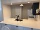 Bright kitchen featuring white cabinets and quartz countertops, stainless steel sink, and modern fixtures at 1917 Nw 50Th Cir, Ocala, FL 34482