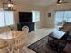 Inviting living room with tile floors, sliding glass doors to the porch, and a ceiling fan at 1917 Nw 50Th Cir, Ocala, FL 34482