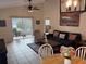 Inviting living room with tile floors, sliding glass doors to the porch, and a ceiling fan at 1917 Nw 50Th Cir, Ocala, FL 34482