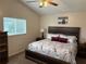 Comfortable bedroom with a ceiling fan, and a large window letting in plenty of natural light at 1917 Nw 50Th Cir, Ocala, FL 34482