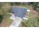 A birds-eye view shows a well-maintained roof, garage and landscaped yard surrounding this lovely home at 2045 Marion County Rd, Weirsdale, FL 32195