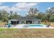 Expansive backyard with pool, spa, and gazebo, perfect for outdoor entertaining and relaxation at 2045 Marion County Rd, Weirsdale, FL 32195