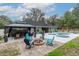 Spacious backyard boasting a fire pit, gazebo, pool, and ample seating, perfect for outdoor living at 2045 Marion County Rd, Weirsdale, FL 32195