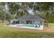 Large backyard featuring a sparkling pool, gazebo, and lush landscaping for outdoor enjoyment at 2045 Marion County Rd, Weirsdale, FL 32195