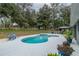 Tranquil backyard featuring a refreshing pool, spa, and gazebo, surrounded by lush greenery at 2045 Marion County Rd, Weirsdale, FL 32195