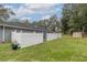 View of the backyard with well-maintained lawn and privacy fencing, creating a serene outdoor space at 2045 Marion County Rd, Weirsdale, FL 32195