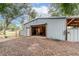 Large barn with an open door and wooden beams, showcasing ample storage space and rustic charm on the property at 2045 Marion County Rd, Weirsdale, FL 32195