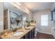 Bathroom featuring double sinks, granite countertops, and large mirror at 2045 Marion County Rd, Weirsdale, FL 32195