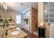 Bathroom featuring double sinks, granite countertops, walk-in shower, and soaking tub at 2045 Marion County Rd, Weirsdale, FL 32195