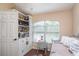 Cozy bedroom with built-in shelving, large window, and comfortable daybed at 2045 Marion County Rd, Weirsdale, FL 32195