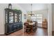 Traditional dining room with rustic wood table, matching chairs and a glass display case at 2045 Marion County Rd, Weirsdale, FL 32195