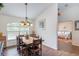 Traditional dining room featuring dark wood table and chairs, a decorative chandelier, and lots of natural light at 2045 Marion County Rd, Weirsdale, FL 32195