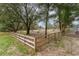 Wide view of fenced pasture area with mature trees and natural ground cover at 2045 Marion County Rd, Weirsdale, FL 32195