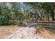 An aerial view of a gated driveway leading to a private property surrounded by trees at 2045 Marion County Rd, Weirsdale, FL 32195