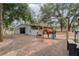 Horse facilities showing the stable and paddock area with a horse present at 2045 Marion County Rd, Weirsdale, FL 32195