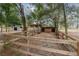 Wood-fenced horse pen area with sandy ground and mature trees providing shade at 2045 Marion County Rd, Weirsdale, FL 32195