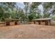 Equestrian property featuring wooden horse stalls with metal roofs, providing shelter and convenience for animal care at 2045 Marion County Rd, Weirsdale, FL 32195