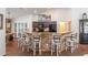 Modern kitchen featuring dark cabinets, stone countertops, a kitchen island, and bar seating at 2045 Marion County Rd, Weirsdale, FL 32195