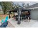 Outdoor seating area with a gazebo, comfortable seating, and a view of the spacious backyard at 2045 Marion County Rd, Weirsdale, FL 32195