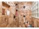 Detailed shot of tiled walk-in shower featuring shower head and tiled shelves at 2045 Marion County Rd, Weirsdale, FL 32195