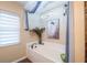 Bright bathroom with soaking tub, window, and decorative accents at 2045 Marion County Rd, Weirsdale, FL 32195