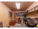 Organized tack room features wooden walls, a concrete floor, shelves and several saddles and bridles at 2045 Marion County Rd, Weirsdale, FL 32195