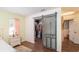 Bedroom featuring walk-in closet with unique barn door and wood floors at 2045 Marion County Rd, Weirsdale, FL 32195