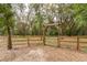 Gated wooden fence surrounds the property, providing security and defining the boundaries of the spacious yard at 2045 Marion County Rd, Weirsdale, FL 32195